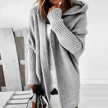 
An oversized grey hoodie dress in a cozy knit fabric featuring long sleeves, a hooded neckline, and convenient pockets, shown in an XL size.