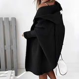 Oversized grey hoodie dress with long sleeves, featuring a cozy knit texture and pockets, reaching knee-length.