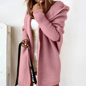 Oversized rose-colored hoodie dress in XL, featuring cozy knit fabric with long sleeves, a comfortable hood, and convenient pockets.