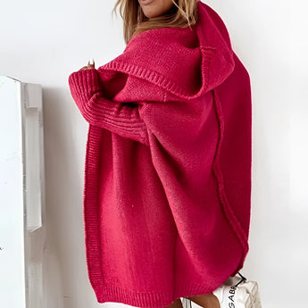 Oversized grey hoodie dress made of cozy knit material with pockets, featuring a relaxed fit with long sleeves and a comfortable neckline.
