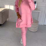 Oversized grey hoodie and leggings set, showcasing trendy urban streetwear style on a model standing with pink shoes, highlighting the neckline, sleeves, and waistline.