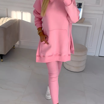 Oversized grey hoodie and leggings set, showcasing trendy urban streetwear style on a model standing with pink shoes, highlighting the neckline, sleeves, and waistline.