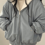 Women's oversized grey puffer jacket in size XL, featuring a high collar and long sleeves, designed for fashionable winter wear.