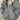 Women's oversized grey puffer jacket in size XL, featuring a high collar and long sleeves, designed for fashionable winter wear.