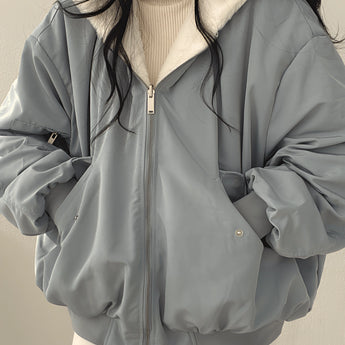 Women's oversized grey puffer jacket in size XL, featuring a high collar and long sleeves, designed for fashionable winter wear.