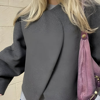 Oversized grey sweater paired with a gold chain bag, showcasing trendy women's casual wear. The sweater features long sleeves, a relaxed fit, and is styled with a focus on the shoulder and waist area.
