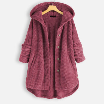 
Image of an oversized hooded knit sweater coat in chunky taupe, styled as a cardigan. The sweater features long sleeves and a relaxed fit, ideal for winter wear. The material appears woolen, and the design has a cozy, fashionable look.