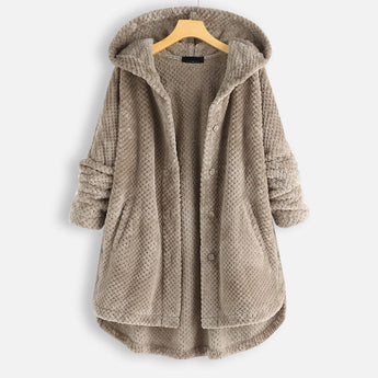 Oversized hooded knit sweater coat in chunky taupe, displayed on a clothes hanger, featuring long sleeves and a cozy, textured design suitable for winter.