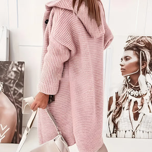 Oversized pink hooded sweater dress featuring a chunky knit design, ideal for winter fashion, with long sleeves and a comfortable fit.