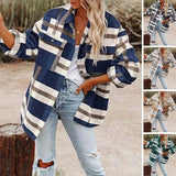 Women's oversized plaid jacket with long sleeves in an autumn street style, featuring a tartan pattern and a casual, fashion-forward look.