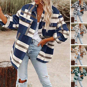 Women's oversized plaid jacket with long sleeves in an autumn street style, featuring a tartan pattern and a casual, fashion-forward look.