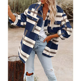 Oversized women's plaid jacket in blue with long sleeves, styled for autumn street fashion. The jacket features a relaxed fit, ideal for a casual and chic look. The model is wearing the jacket over a white outfit, with focus on the jacket's design and pattern.