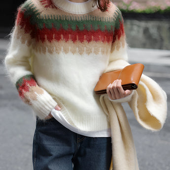 Oversized cream plaid wool scarf with fringe draped over shoulders, styled as an urban chic winter accessory.