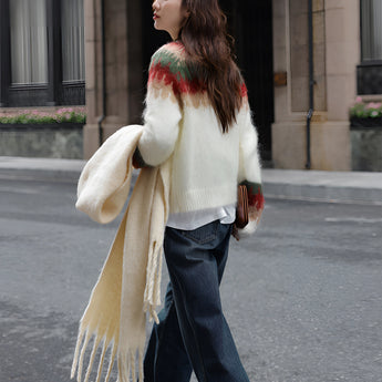 Oversized plaid wool scarf with fringe draped around a person's neck, showcasing a chic winter fashion accessory against an urban backdrop.