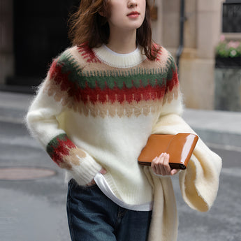 A woman wearing an oversized plaid wool scarf with fringe, draped around her neck and shoulders, featuring a mix of warm colors suitable for a chic urban winter look.