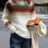 Oversized plaid wool scarf with fringe draped over a person's shoulders, showcasing its urban chic style. The scarf is worn with fashionable outerwear, highlighting its cozy and stylish appeal for winter.