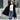 Oversized red fur hooded coat with luxurious texture, worn by a model paired with jeans and eyewear, showcasing a winter fashion look.