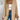 Oversized beige women's chunky knit off-shoulder cardigan in XL size, showcasing a relaxed fit with long sleeves and a cozy texture, styled casually over a pair of jeans.