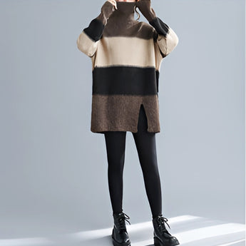 
A woman wearing an oversized turtleneck striped sweater dress made of chunky knit, suitable for winter fashion. The dress has long sleeves and extends to her thighs. The image focuses on the upper body, showing the detailed knit texture and striped pattern of the sweater dress.