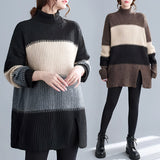 Oversized black and white striped turtleneck sweater dress in chunky knit fabric, showcasing winter fashion with long sleeves and a relaxed fit.