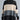 Oversized turtleneck striped sweater dress in chunky knit fabric, featuring black and white stripes with long sleeves, perfect for winter fashion.