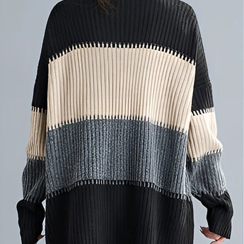 Oversized turtleneck striped sweater dress in chunky knit fabric, featuring black and white stripes with long sleeves, perfect for winter fashion.
