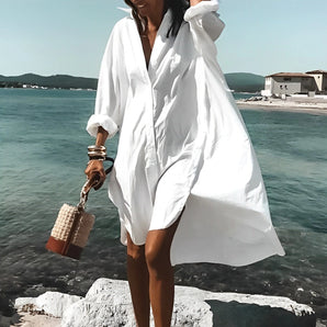 Oversized white beach shirt tunic for women in 5XL, featuring a lightweight and breezy design ideal for summer, worn by a person standing happily by a serene lake under a clear sky.