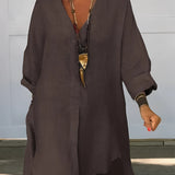 
An oversized white linen blouse with a relaxed fit, featuring a casual chic bohemian style. The blouse has a soft collar, long sleeves, and a comfortable waistline, ideal for summer wear. The model is standing, showcasing the blouse's loose and airy design.