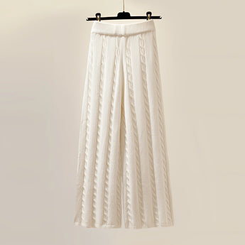 Oversized white turtleneck sweater hanging on a wooden clothes hanger, showcasing its cozy ribbed knit texture and winter-ready design.