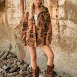 Oversized women's Aztec jacket featuring a boho tribal pattern, worn with fashionable footwear and a hat, highlighting the sleeves and overall style in a casual setting.