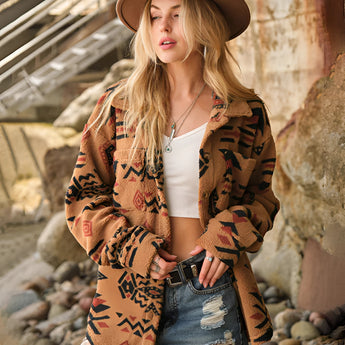 Oversized women's Aztec jacket in beige, featuring a boho tribal pattern, worn by a model. The model is wearing an XL size and accessorized with a hat, showcasing the fashion-forward outerwear.
