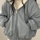 Oversized women's black bomber puffer jacket featuring a trendy winter fashion style with a high collar, long sleeves, and a quilted design for added warmth and comfort.