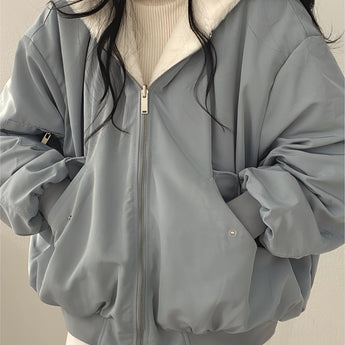 Oversized women's black bomber puffer jacket featuring a trendy winter fashion style with a high collar, long sleeves, and a quilted design for added warmth and comfort.