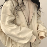 Oversized women's black bomber puffer jacket with a trendy winter fashion design, featuring a high collar, long sleeves, and a quilted pattern, styled on a model with visible shoulder and arm details.