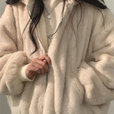 Oversized women's black bomber puffer jacket with a high collar and long sleeves, showcasing trendy winter fashion design.
