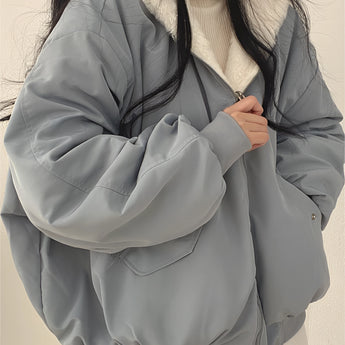Oversized women's black bomber puffer jacket featuring a trendy collar, long sleeves, and a stylish design perfect for winter fashion.
