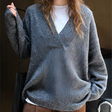 Oversized gray knit sweater for women featuring a deep V-neck design, perfect for cozy winter wear.