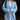Oversized women's blue knit sweater featuring a deep V-neck design, long sleeves, and a cozy fit suitable for winter wear. The sweater appears to have a relaxed fit around the shoulders and waist, effectively showcasing its casual and comfortable style.