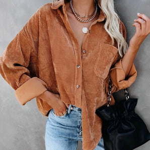 Oversized women's burnt orange corduroy shirt styled for autumn fashion, shown in a white color variant with long sleeves, paired with jeans.