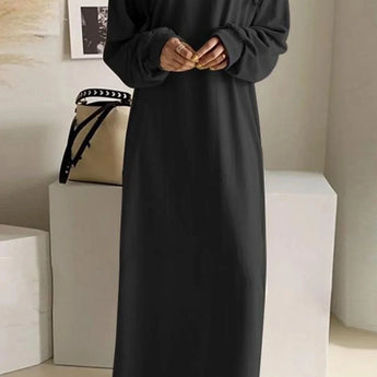 Oversized women's long gray hoodie dress made from a comfortable cotton blend, featuring a relaxed fit with long sleeves and a fitted shoulder design.