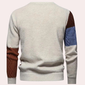Multi-color men's sweater with contrasting sleeves and a patchwork design, featuring a grey base, a round neck, and fitted at the waist, suitable for stylish outerwear.
