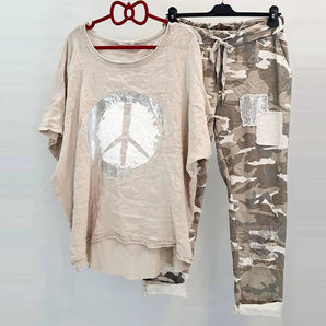 Peace sign t-shirt and camouflage cargo pants set hanging on a clothes hanger, featuring a grey t-shirt with a peace sign design, short sleeves, and a round neckline.