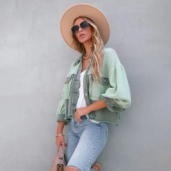 Peach lace blouse paired with acid wash jeans, complemented by white sneakers. Model accessorized with a stylish fedora hat and sunglasses, showcasing a chic summer outfit.