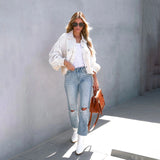 Peach lace blouse paired with acid wash jeans and white sneakers, styled as a chic summer outfit.