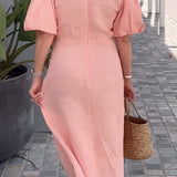Peach linen V-neck wrap dress with a flattering waist tie, featuring short sleeves and a knee-length skirt, elegantly designed for mature women. The dress is displayed in a soft pink hue, capturing a chic summer look.