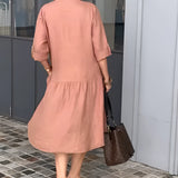 Women's peach mid-length spring dress with sleeves and a fitted waist, featuring a lightweight and elegant design suitable for casual wear.