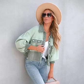 
A person wearing a peach ruffled jacket, paired with jeans and glasses, standing outdoors. The jacket is a trendy piece of spring urban wear in a green variant, size XL.