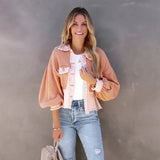 Smiling person wearing a peach ruffled jacket, styled for spring urban wear, in a pink XL variant, with focus on the jacket's shoulder and sleeve details.