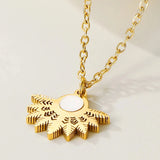 A gold floral pendant necklace with an amber pearl centerpiece, designed by YA-CHAN, featuring a delicate metal chain and elegant circle design, perfect as a fashion accessory.