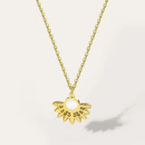 Gold tone pearl centerpiece necklace by YA-CHAN with a designer gold floral pendant, featuring a delicate chain and elegant body jewelry design.